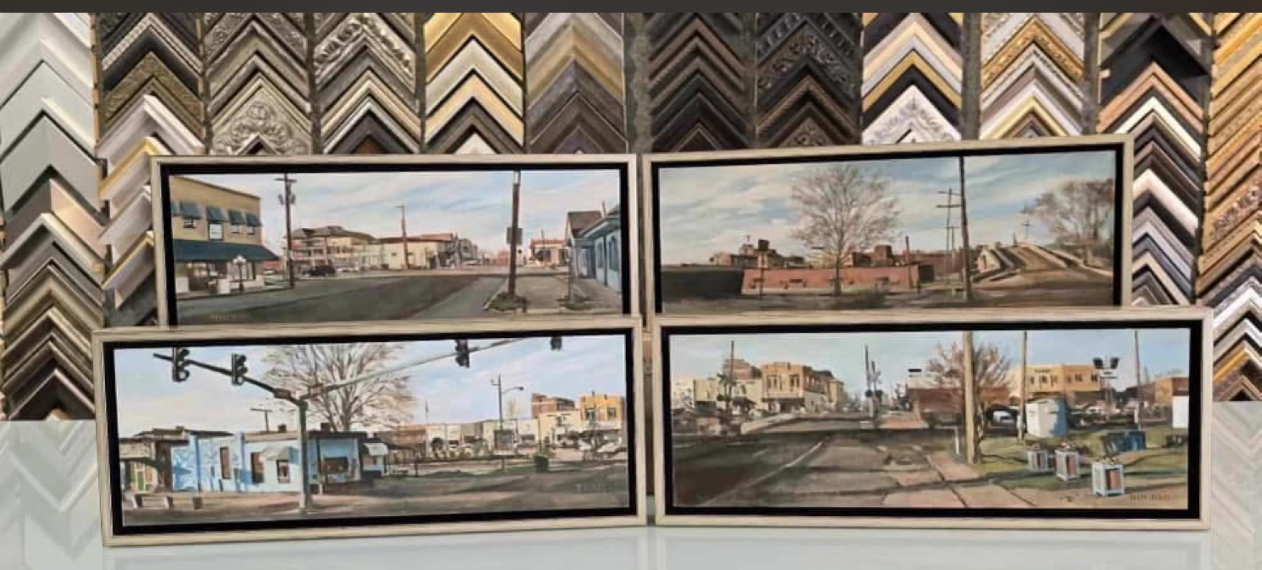 Four downtown Ruston watercolor paintings in white float frames by The Frame Up in Ruston, Louisiana