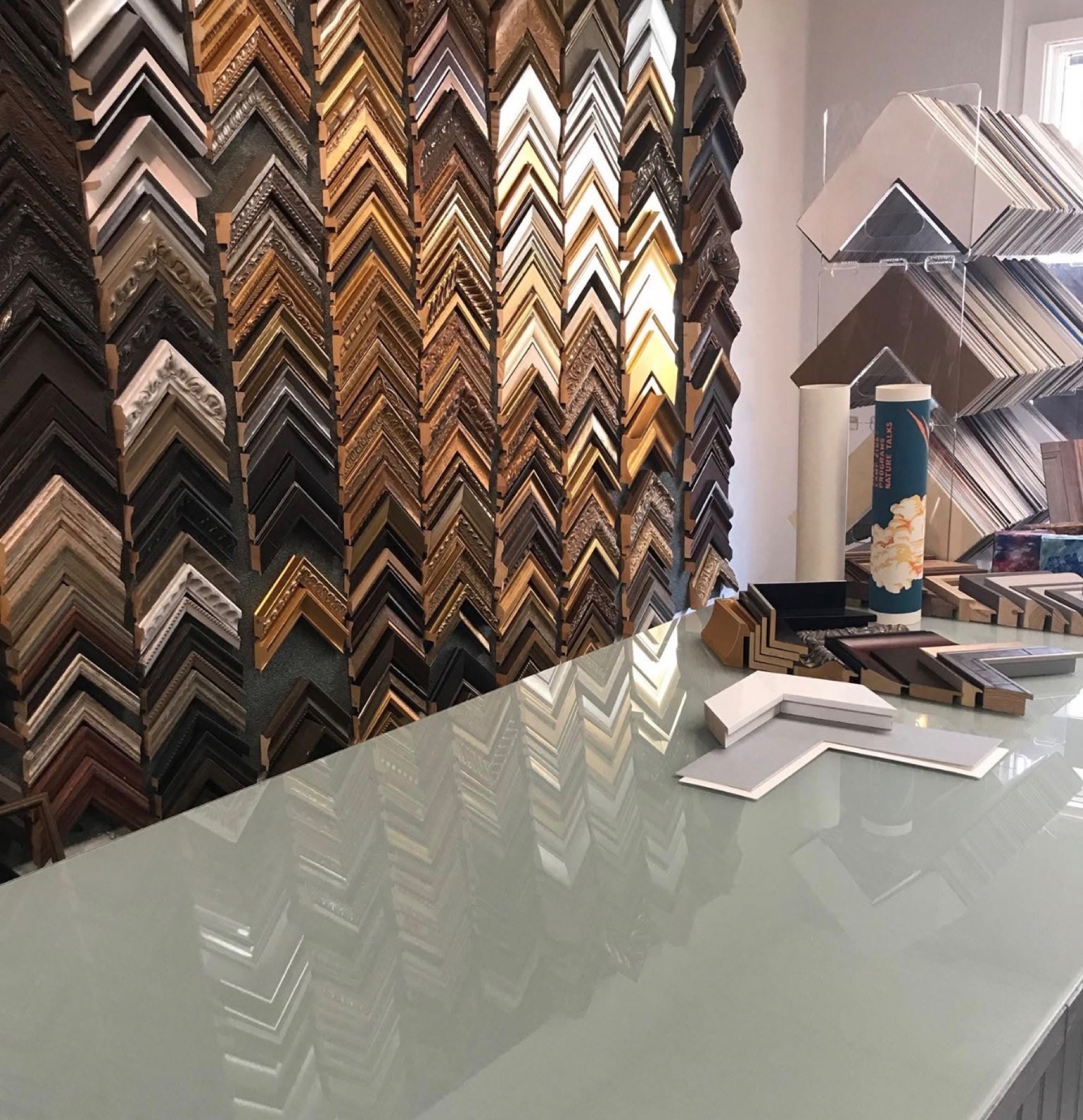 Wall of more than 100 moulding profile samples for custom picture framing at The Frame Up in Ruston, Louisiana